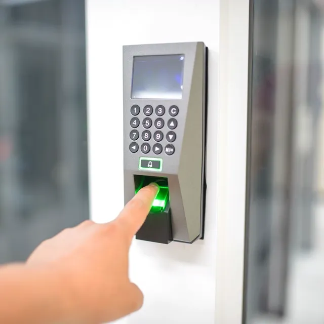 A member checking in at a biometric reader by the door