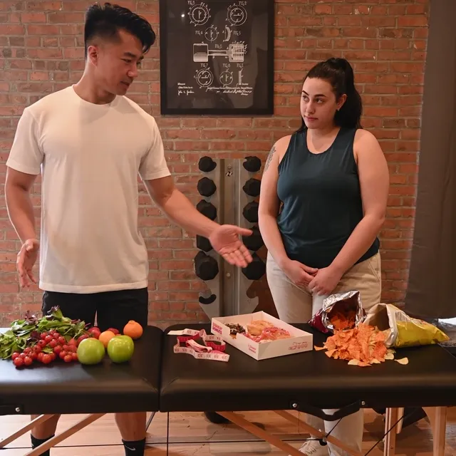 A trainer talking a member through healthy food choices